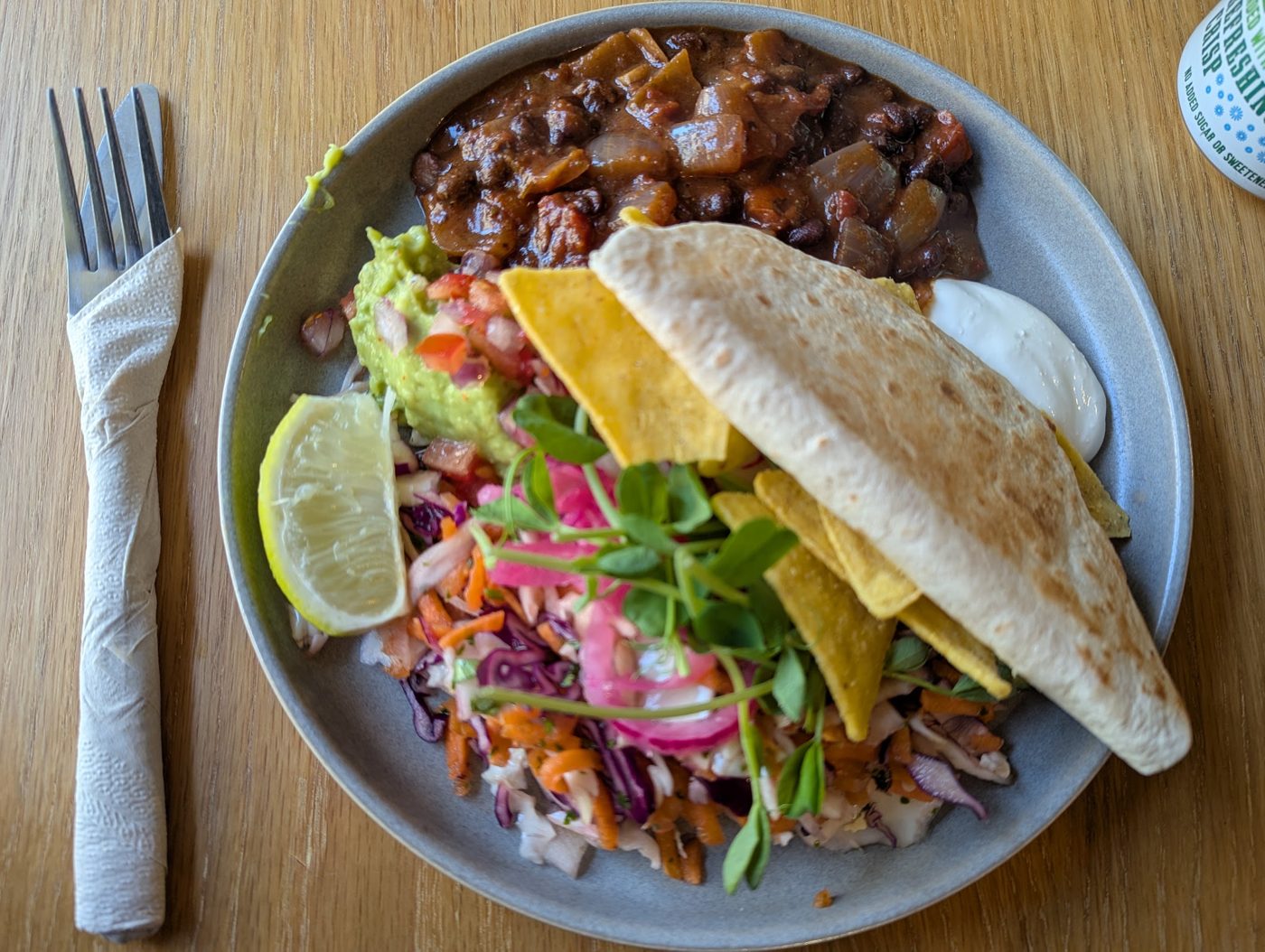 Chilli with salad, tortilla chips and a folded quesadilla