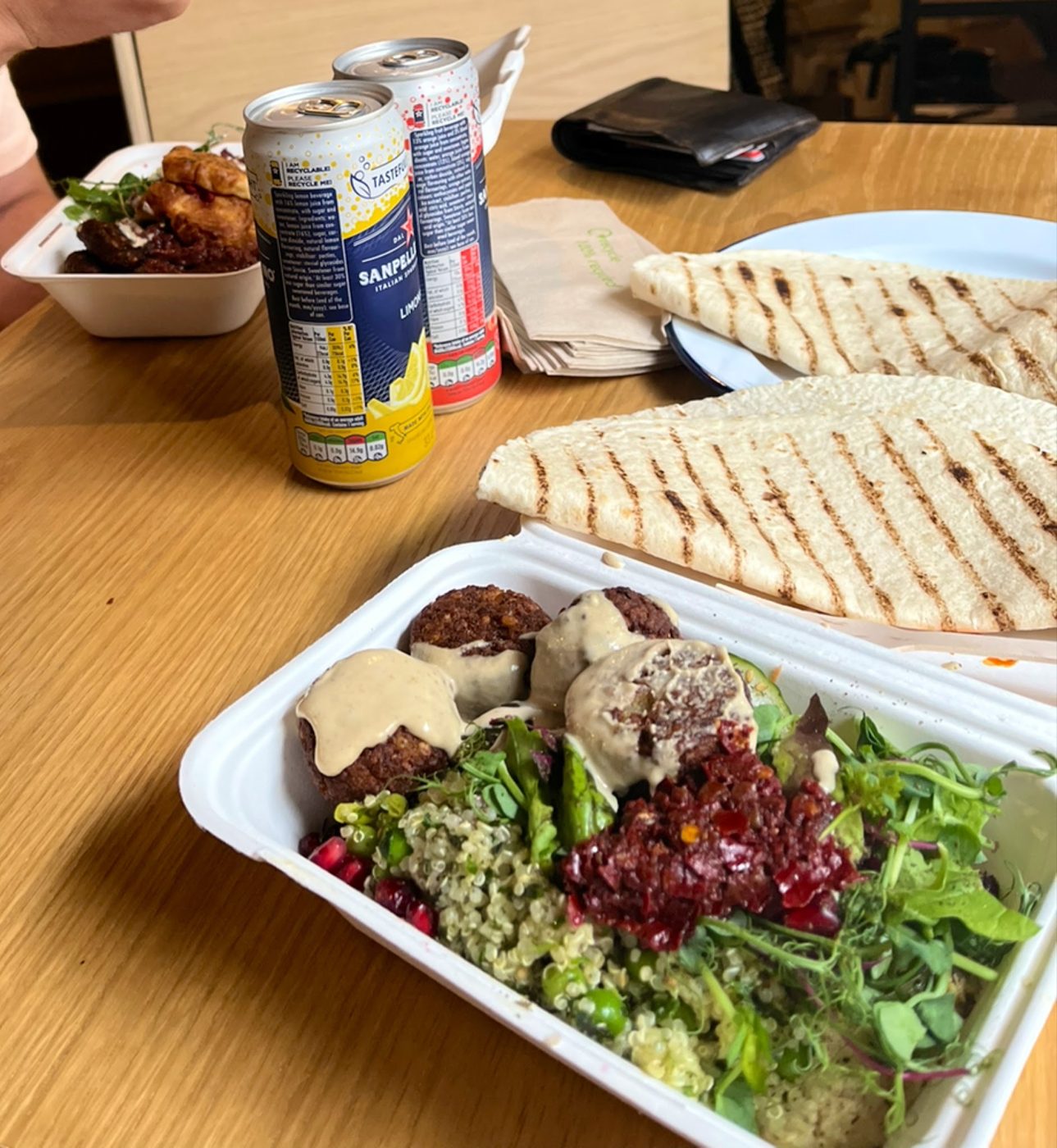 Falafel, salad and grilled flatbread in a takeaway box