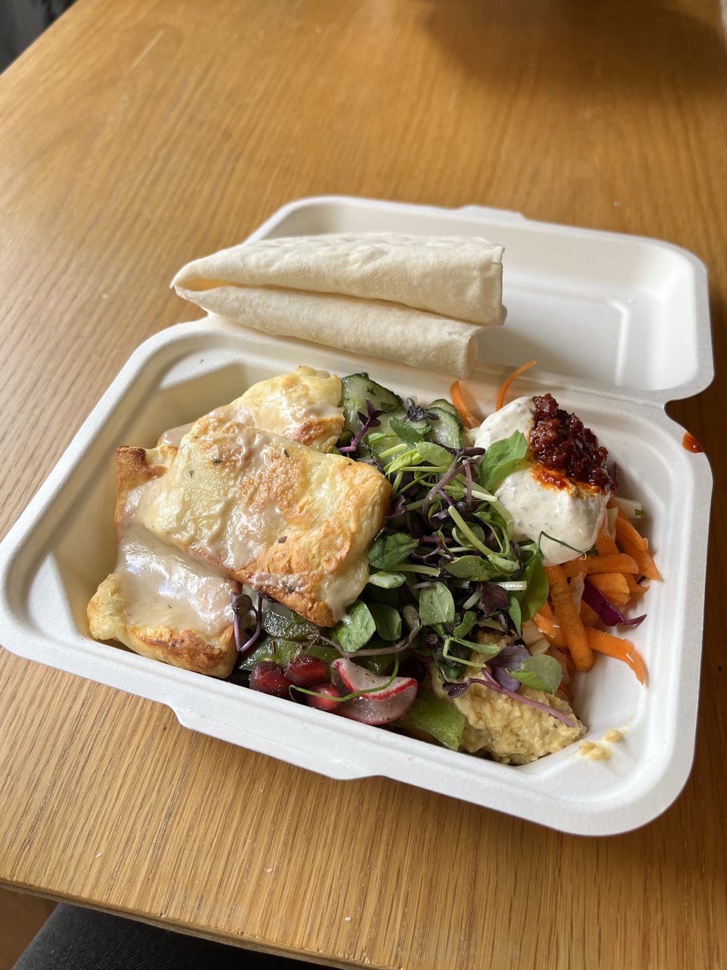 Halloumi, salad and flatbread in a takeaway box
